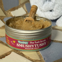 Load image into Gallery viewer, Tub of 'Smushytushy' tush scrub with a wooden applicator on a tiled surface.
